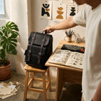Black leather backpack in a creative studio