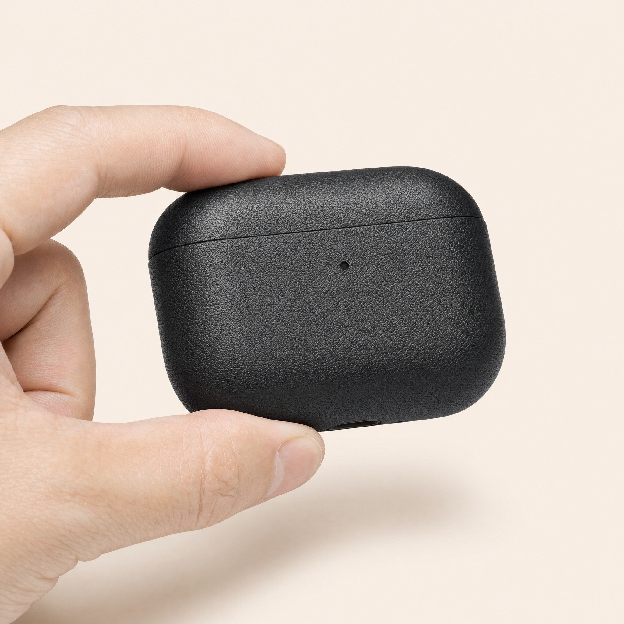 The case held between finger and thumb, showing its size