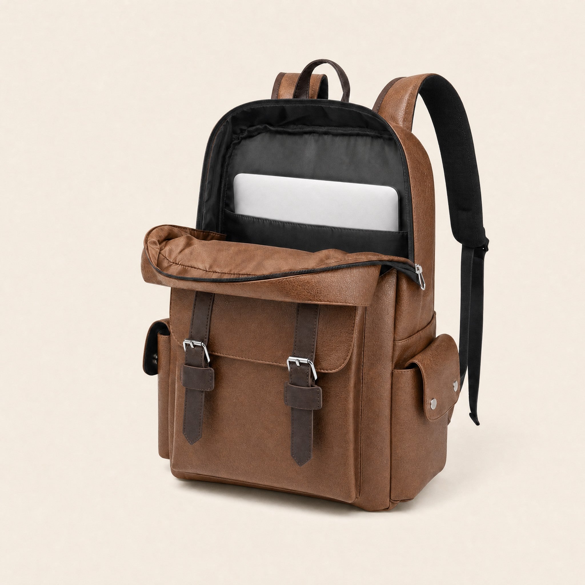 Light brown leather backpack open, showing padded laptop sleeve
