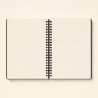 Spiral notebook open flat, showing the lined pages