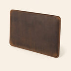 Dark brown leather laptop sleeve, three-quarter view