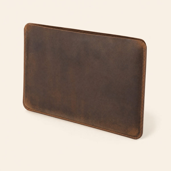Dark brown leather laptop sleeve, three-quarter view