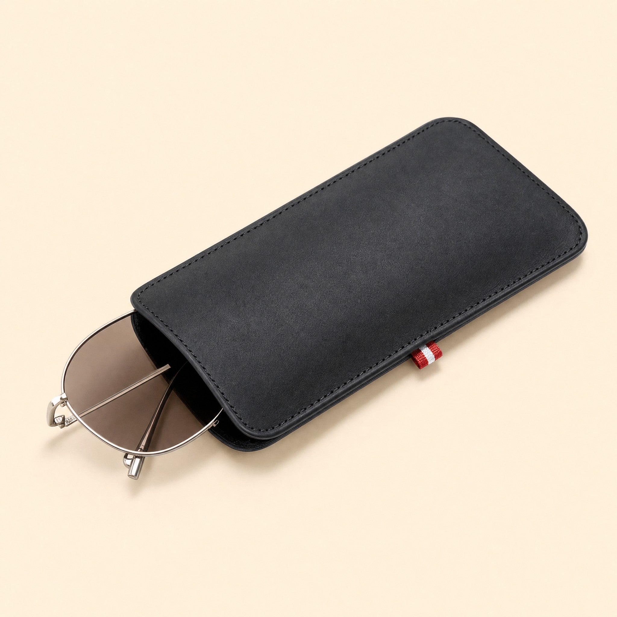 Sunglasses sliding into the pouch under the flap